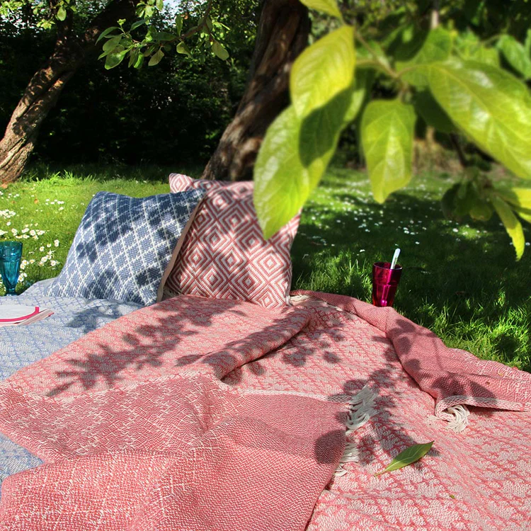 Woven trellis throw in coral pink