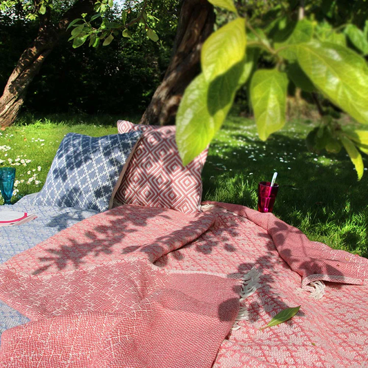 Woven trellis throw in coral pink