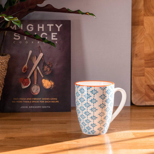 Blue pattern mug with orange trim