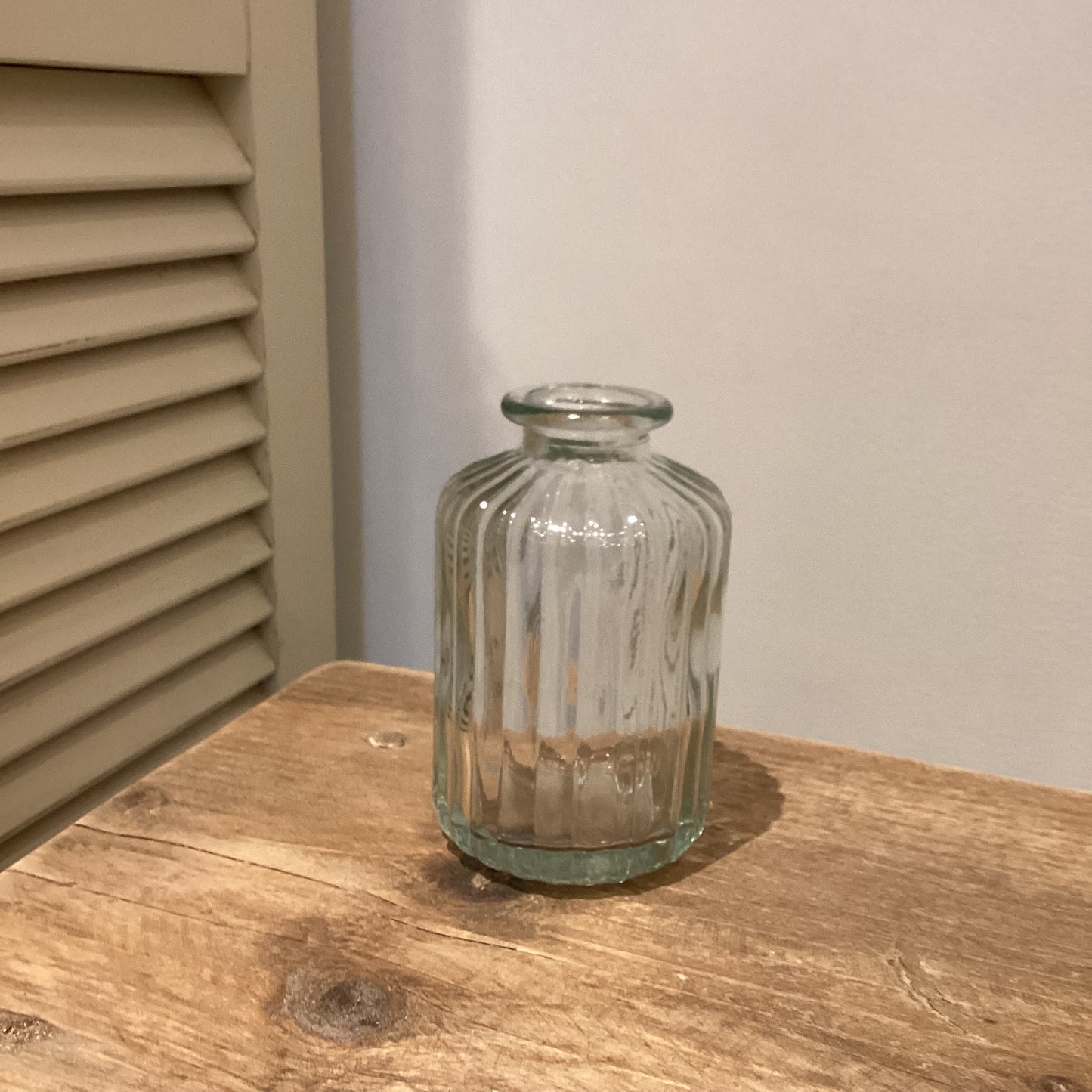 Small ribbed clear glass bottle