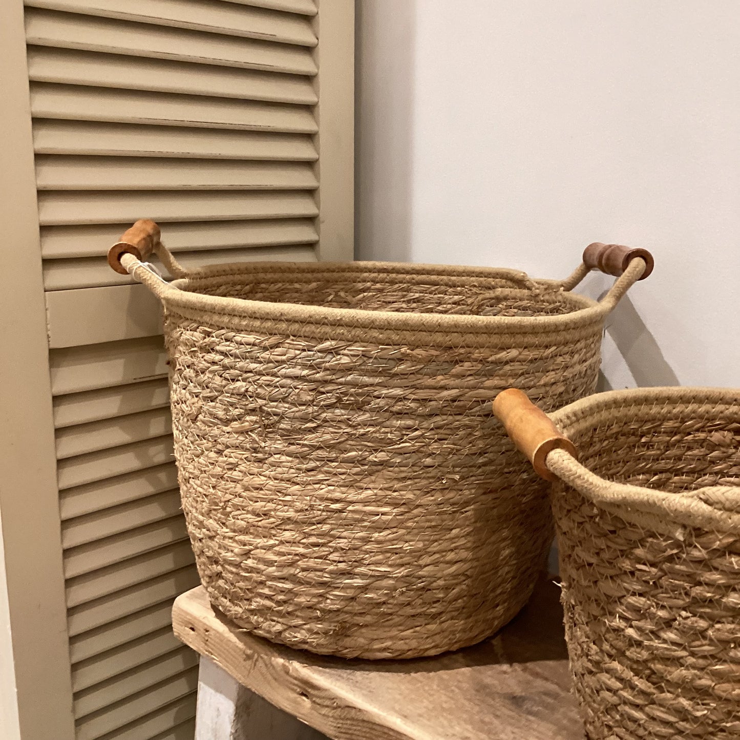 Woven basket with wooden handles